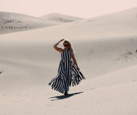 Woman walking in the desert Stock Photo
