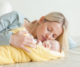 Young mother holding her sleeping baby Stock Photo 06