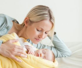 Young mother holding her sleeping baby Stock Photo 07