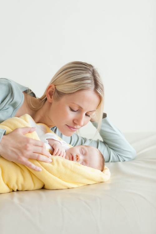 Young mother holding her sleeping baby Stock Photo 07