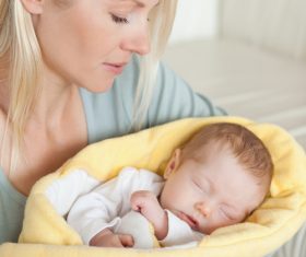Young mother holding her sleeping baby Stock Photo 08