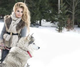 Young woman with wolf dog in snow Stock Photo 03