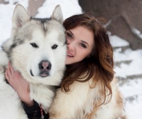 Young woman with wolf dog in snow Stock Photo 04