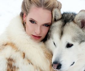 Young woman with wolf dog in snow Stock Photo 07