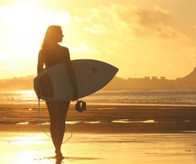 Beautiful woman holding a surfboard Stock Photo