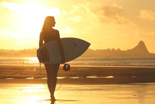 Beautiful woman holding a surfboard Stock Photo