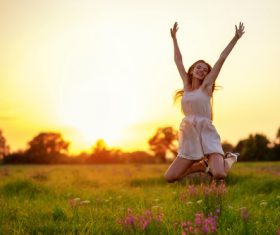 Beautiful woman jumping up in mid air Stock Photo