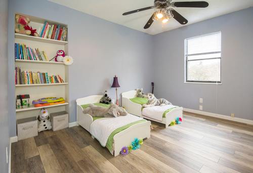 Bookshelves and cots in childrens rooms Stock Photo