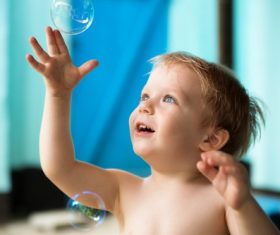 Children catching bubble Stock Photo