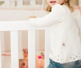 Cute blond little girl looking at newborn baby Stock Photo 01