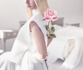 Elegant young blonde holding a beautiful pink rose Stock Photo 01