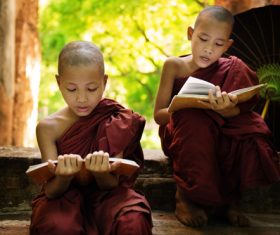 Little monk reading book Stock Photo
