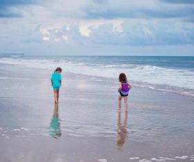 Little sisters walking by the sea Stock Photo