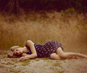 Lying on the ground posing woman Stock Photo
