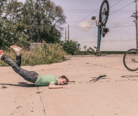 Man Falling Off Bike Stock Photo