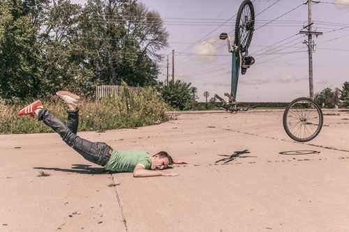 Man Falling Off Bike Stock Photo