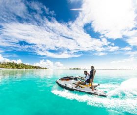 Men and women driving speedboats on the water Stock Photo
