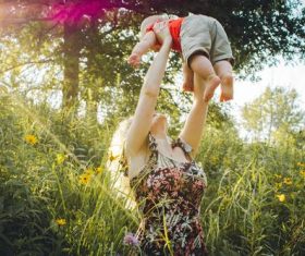 Mother lifted the baby up high Stock Photo