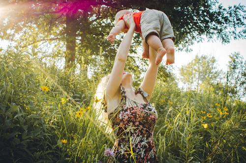 Mother lifted the baby up high Stock Photo