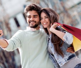 Portrait of a couple with shopping bags in city Stock Photo 04