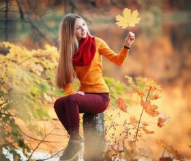 Pretty girl holding yellow maple leaf Stock Photo