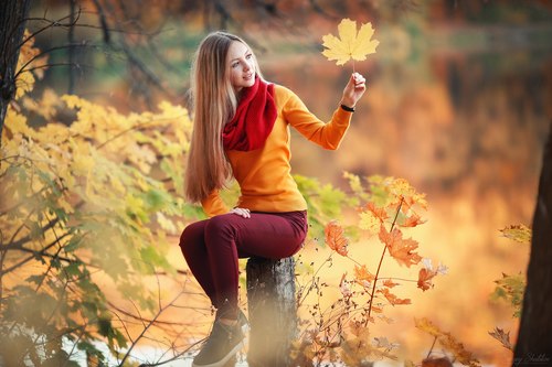 Pretty girl holding yellow maple leaf Stock Photo