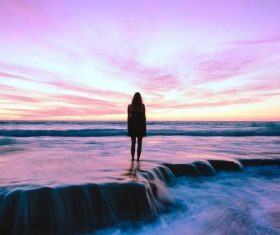 Seascape sunset and people at dusk Stock Photo