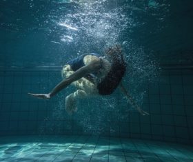 Somersault people in the water Stock Photo