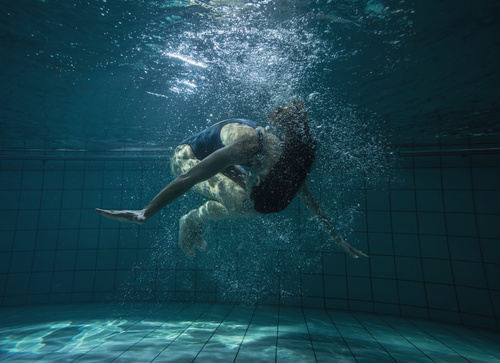 Somersault people in the water Stock Photo
