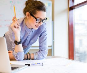 Stock Photo Woman looking at design drawings