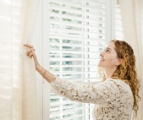 Stock Photo Woman opens the curtain 01