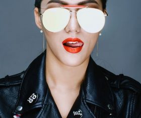 With sunglasses wearing a black leather jacket handsome woman Stock Photo