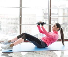 Woman doing abdominal and back exercises Stock Photo