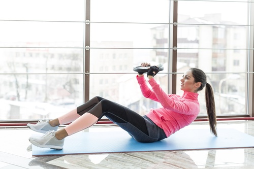 Woman doing abdominal and back exercises Stock Photo