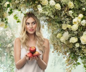 Woman holding apple with flower background Stock Photo