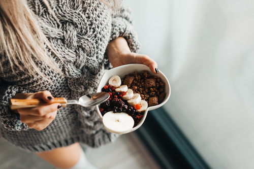 Woman in Knitted Sweater Enjoying Morning Breakfast Stock Photo