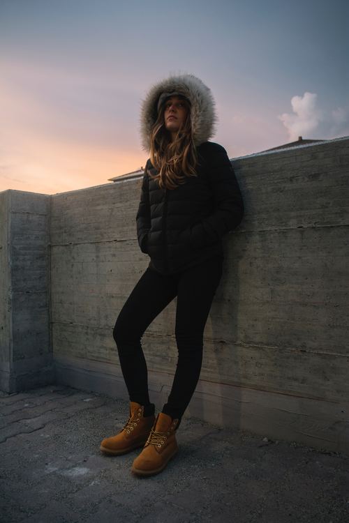 Woman wearing duck down jacket standing outdoors Stock Photo