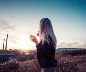 Young Girl Drinking Lemonade and Overlooking the City Stock Photo