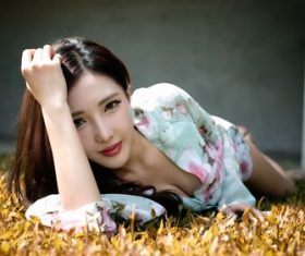 Asian girl lying on the lawn Stock Photo
