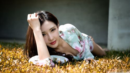 Asian girl lying on the lawn Stock Photo