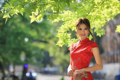 Asian girl wearing red cheongsam smiling Stock Photo