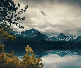 Cloudy sky snow mountain lake scenery Stock Photo