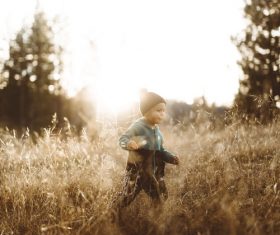 Cute little boy on the grass outdoors Stock Photo