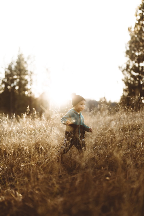 Cute little boy on the grass outdoors Stock Photo