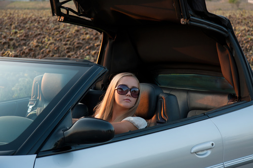 Driving sports car wearing sunglasses beauty Stock Photo