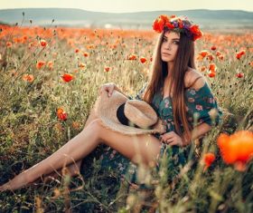 Female model sitting in wildflowers posing Stock Photo