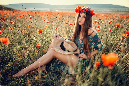 Female model sitting in wildflowers posing Stock Photo