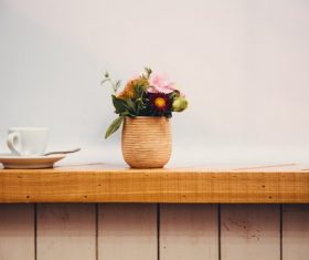 Flower arrangement and coffee cup on the windowsill Stock Photo