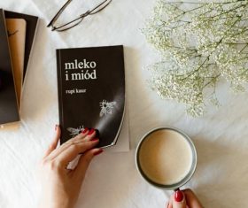 Girl drinking coffee while reading book Stock Photo 01