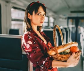Girl holding food basket in the train compartment Stock Photo